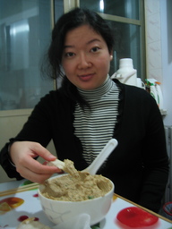 Joyce tries hummus prepared by David